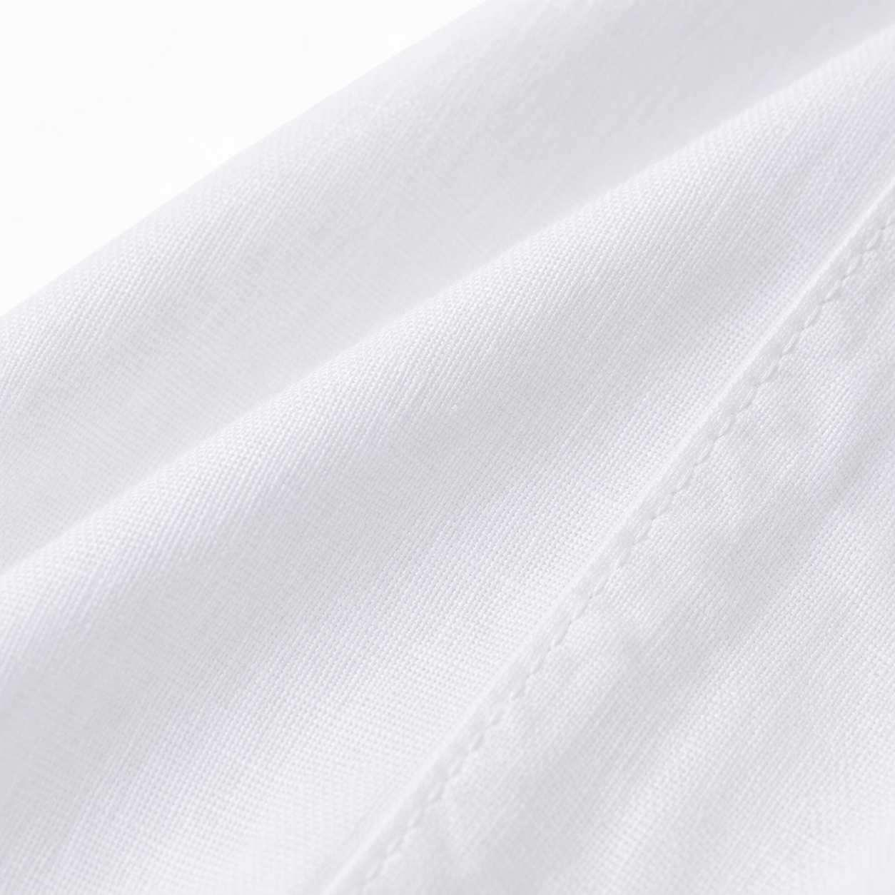 Close-up of white cotton-linen fabric and tonal stitching